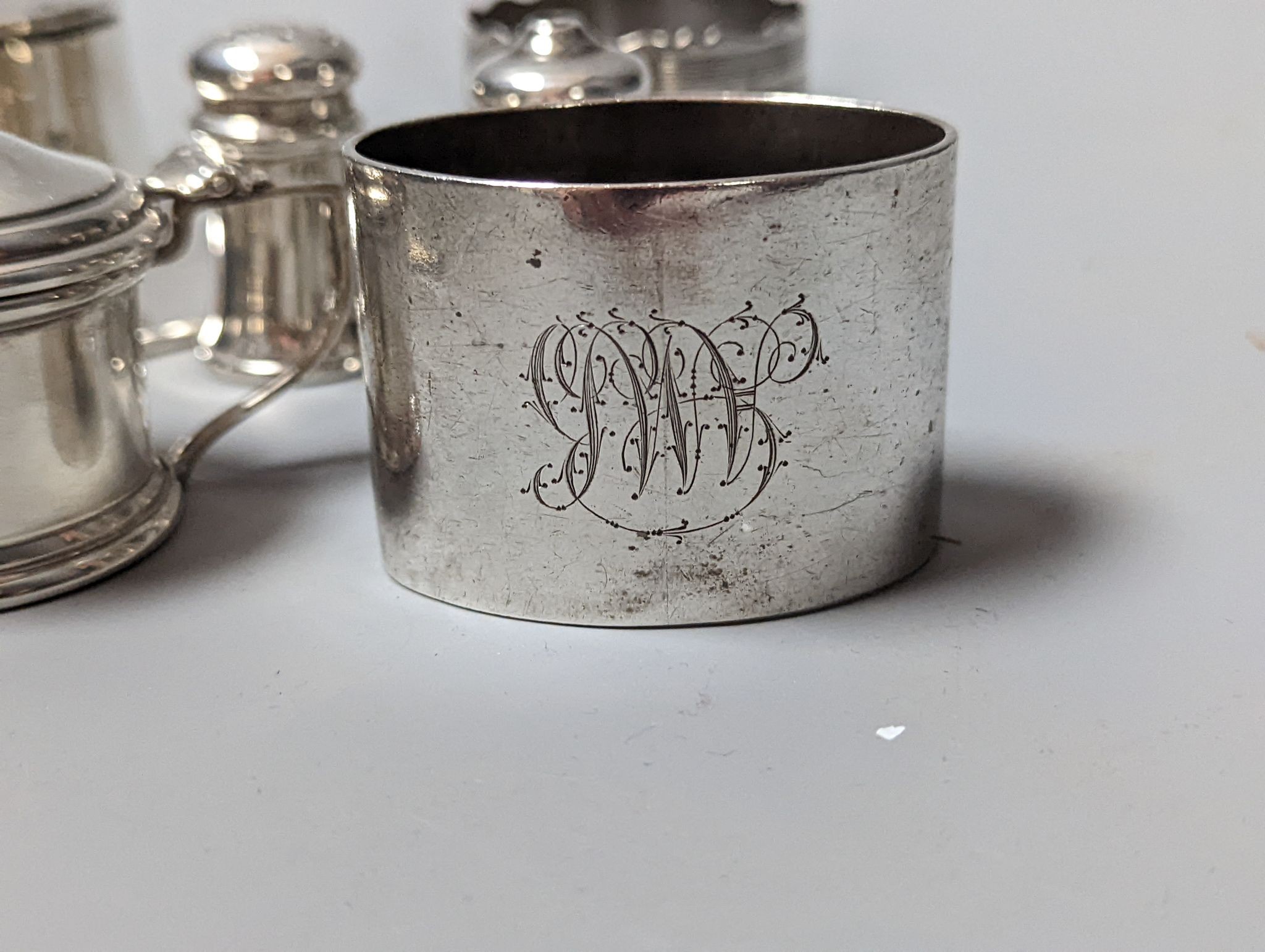 A modern Queens' Silver Jubilee commemorative silver paper knife, 16.9cm, London, 1977, a silver inkwell, three silver napkin rings and three silver condiments.